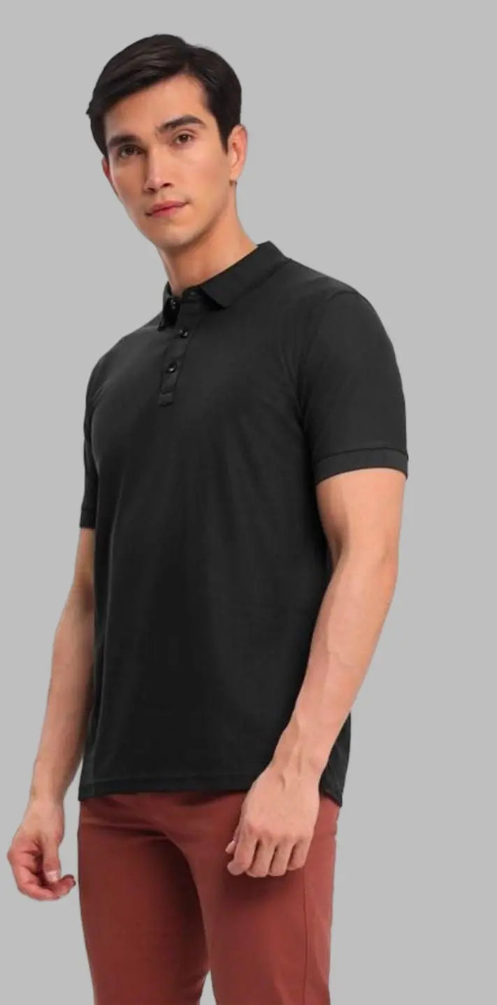 Man wearing a black polo shirt and red pants on a white background