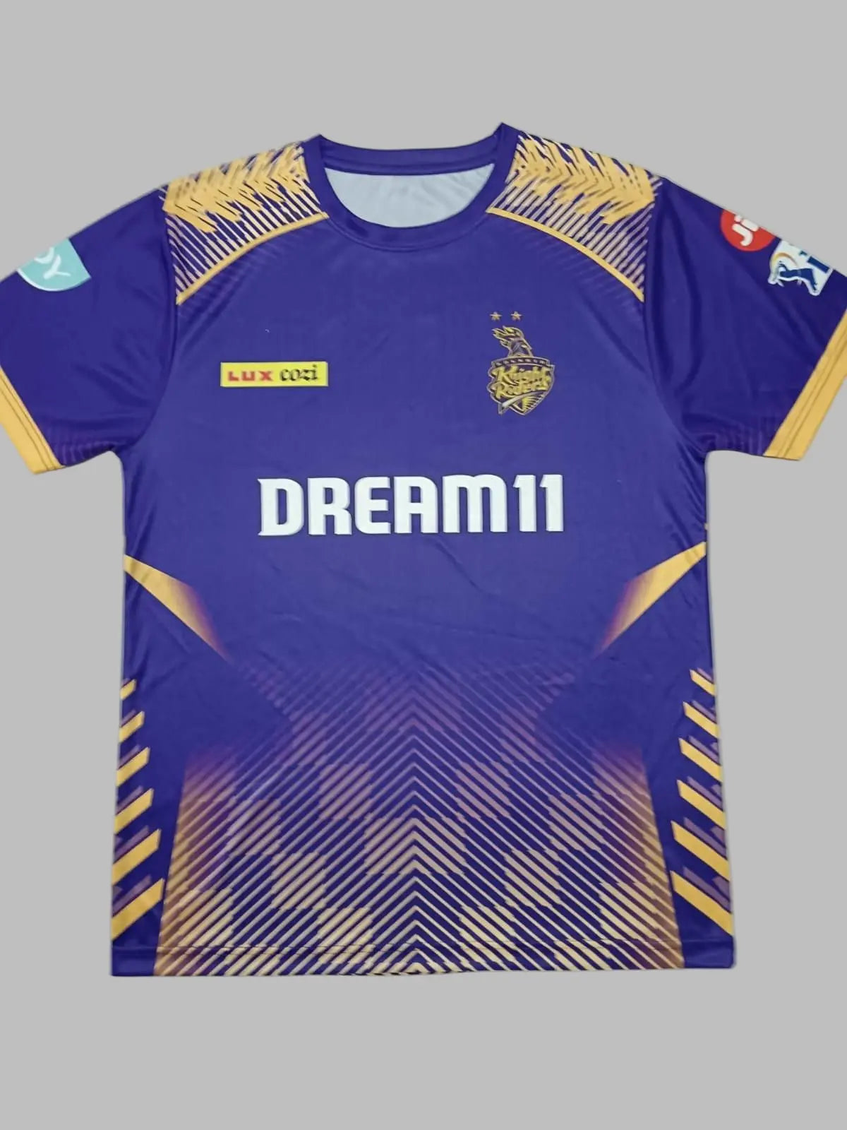 Purple sports jersey with gold accents and 'Dream11' branding on a light gray background