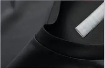 Person wearing a black and gray athletic shirt with close-up of fabric texture.