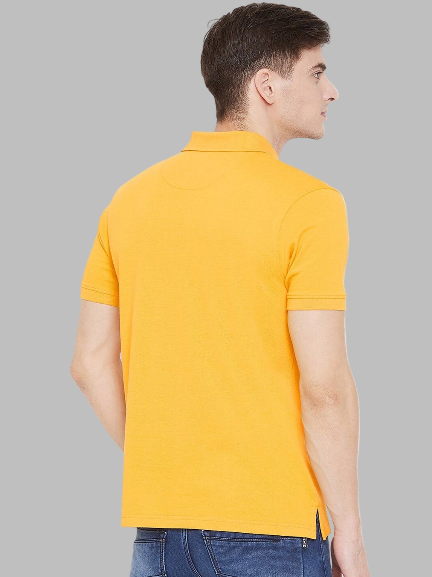 Man wearing a yellow polo shirt on a white background