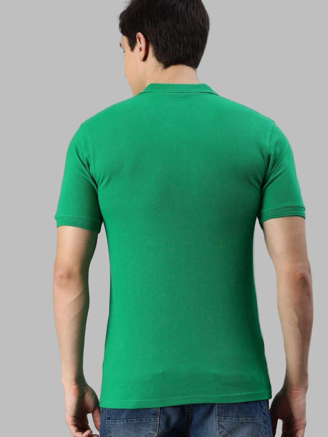 Person wearing a green t-shirt on a gray background