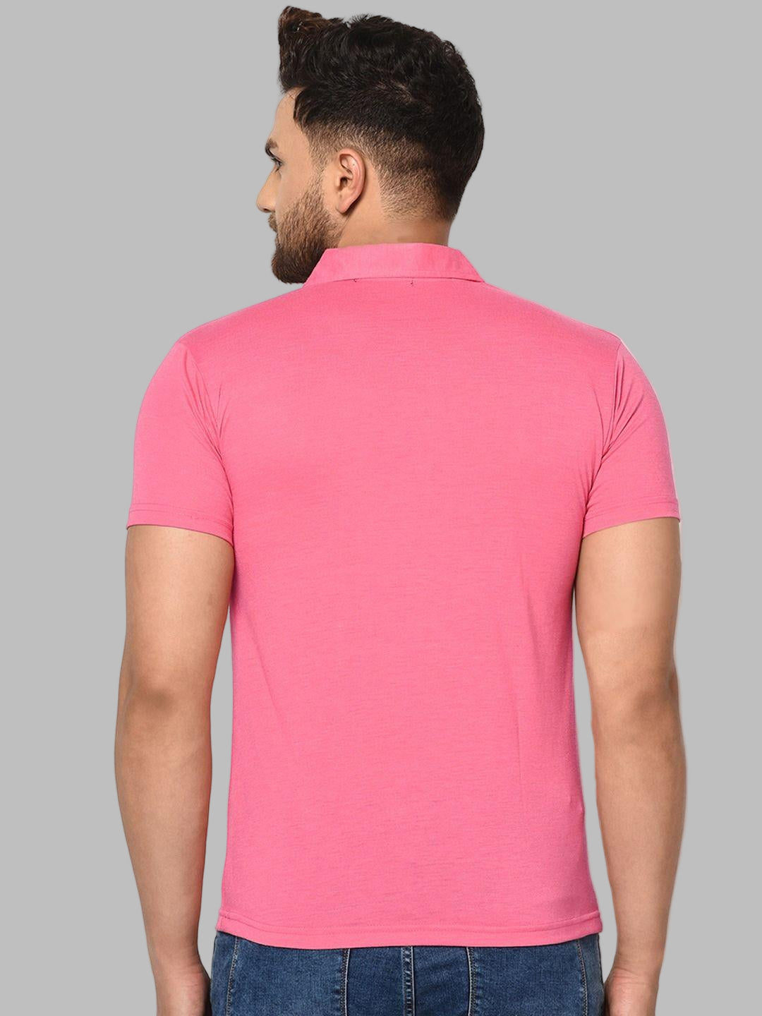 Man wearing a pink polo shirt against a white background