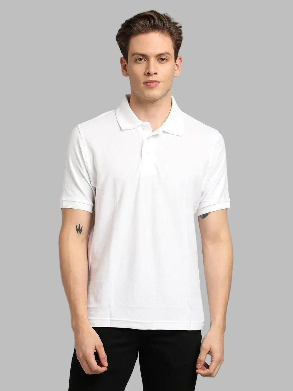 Man wearing a white polo shirt against a gray background