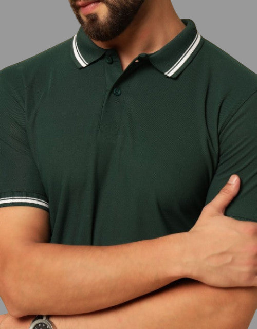 Man wearing a green polo shirt with white trim on a beige background