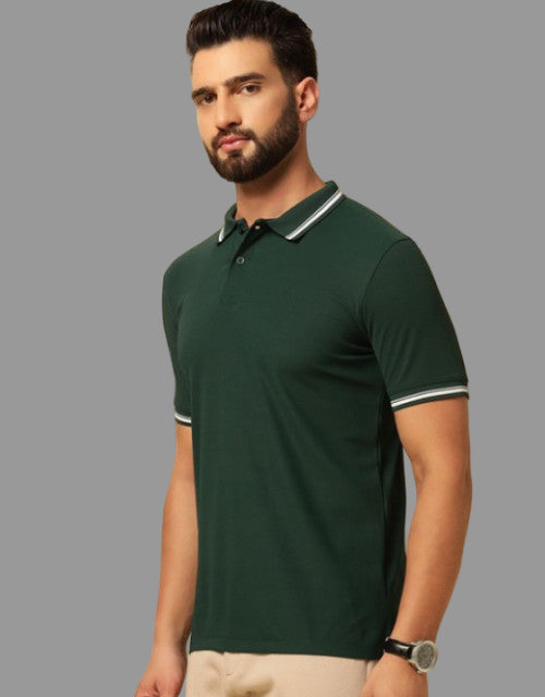 Man wearing a green polo shirt with white trim on a beige background