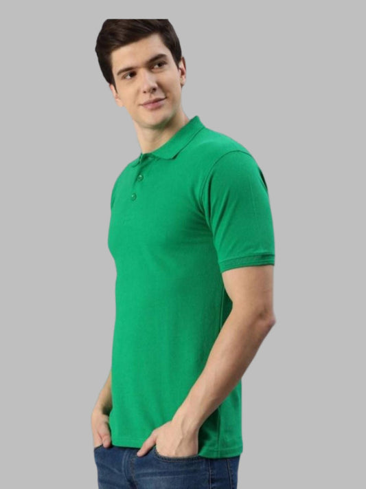 Man wearing a green polo shirt against a gray background