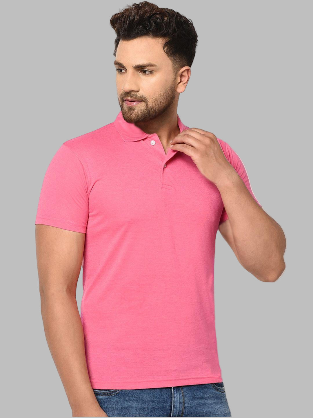 Man wearing a pink polo shirt against a white background